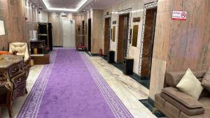 a long hallway with a purple carpet in a store at ظلال النزلاء in Jarwal