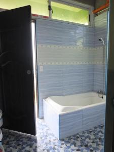 a bathroom with a bath tub and a tub at YahVilla Homestay in Baguio