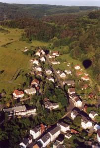 an aerial view of a village with houses and trees at Heidi`s Ferienhaus in Mittenaar