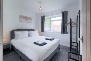 Ένα ή περισσότερα κρεβάτια σε δωμάτιο στο 3 Bed Bungalow In Woking