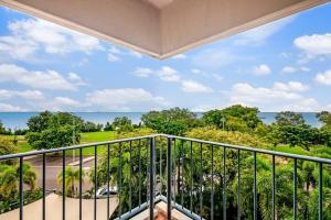 a balcony with a view of the ocean at Corner Balcony Suite on the Esplanade with Pool in Darwin
