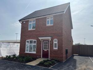a red brick house with a red door at Cheshire East Detached 3BD, Central home CW1 in Crewe