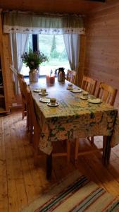 a dining room table and chairs with a table and a table and chairsuggest at Seterstue i Beiarn - Beiarn Lodge in Beiarn