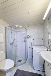 a bathroom with a shower and a toilet and a sink at Tampereen kunkku in Tampere