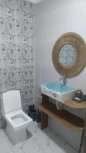 a bathroom with a sink and a toilet at The Baobab Homestay in Dodoma