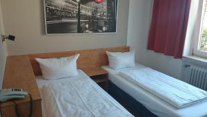 Ένα ή περισσότερα κρεβάτια σε δωμάτιο στο Hotel Novostar