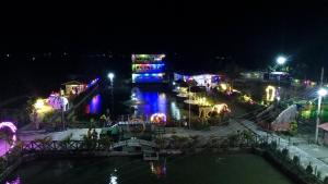 a view of a city at night with lights at Pokhari Cottage Private Limited in Bahāsi