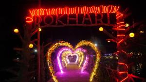 a gate with a sign in the shape of a heart at Pokhari Cottage Private Limited in Bahāsi