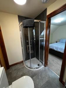 a bathroom with a shower in a room with a bed at Tewit Castle Adventures in Eryholme