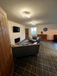 a living room with a couch and a tv at Tewit Castle Adventures in Eryholme