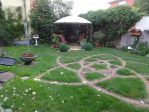 a garden with a peace sign in the grass at Ferienwohnungen Haus Leonore in Stendal