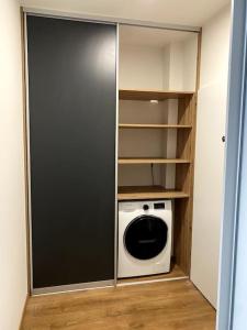 a small kitchen with a washer and dryer at Kramare 303 in Bratislava