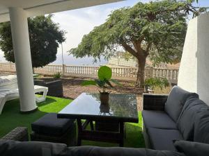 a living room with a couch and a table at Views of Sunsets in Taurito