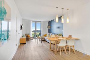 a living room with a table and a couch at Spectacular Balcony - Near Beach - Gym - Pool in Hallandale Beach