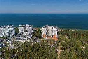 an aerial view of a city with tall buildings and the ocean at Porta Mare - Apartment with Sea View Balcony & Parking by Renters in Dziwnówek