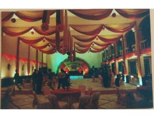 a group of people standing in a room with a stage at Hotel Sports Club Of Jabalpur, Jabalpur in Jabalpur