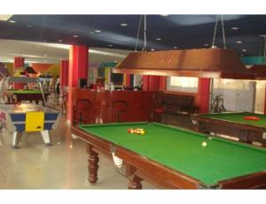 a billiard room with a pool table in a room at Hotel Sports Club Of Jabalpur, Jabalpur in Jabalpur