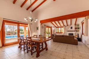 a living room with a table and a couch at Beach Villa Can Carles by Sealand Villas in Port de Pollensa