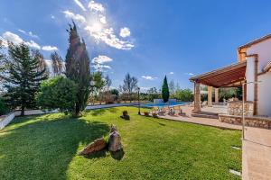 a yard with statues of animals on the grass at Beach Villa Can Carles by Sealand Villas in Port de Pollensa