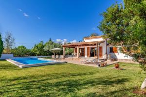 a house with a swimming pool in a yard at Beach Villa Can Carles by Sealand Villas in Port de Pollensa
