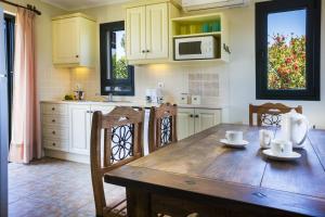 a kitchen with a wooden table and chairs at Villa Haris in Argostoli