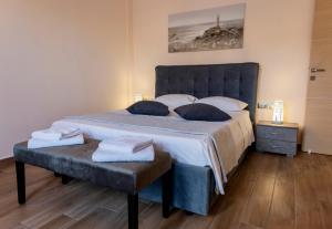 a bedroom with a large bed with a blue headboard at Αegean Εyes in Tinos Town