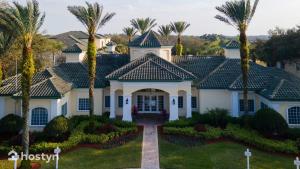 a large white house with palm trees at Incredible apartment just 15 minutes from Disney in Kissimmee