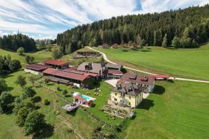 an aerial view of a large house in a field at Hochleben-Chalets am Erlebnisbauernhof Steinerhof in Liebenfels