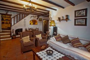 a living room with a couch and a table at Casa El Barbero 1810 in Benaocaz