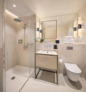 a bathroom with a shower and a toilet and a sink at Dao by Dorsett North London in London