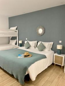 a bedroom with two beds and a mirror on the wall at Marsuites in Armação de Pêra