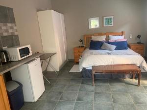 a bedroom with a bed with a microwave and a table at MAM in Mokopane