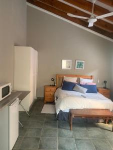 a bedroom with a bed and a desk with a microwave at MAM in Mokopane