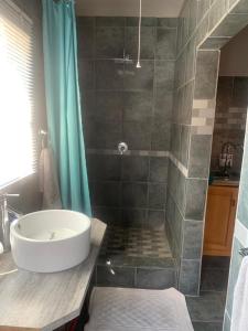 a bathroom with a tub and a sink and a shower at MAM in Mokopane