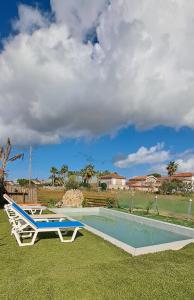 a swimming pool with a bench and a table at Konstantinos holidays house in Laganas