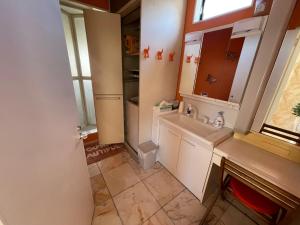 a bathroom with a sink and a mirror at near shibuya quiet residential area in Tokyo