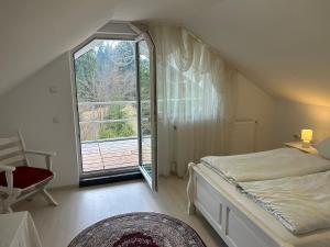 a bedroom with a bed and a large window at Casa Avram in Suceviţa