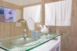 a bathroom with a sink and a mirror at Villa Bikini in Punta Cana
