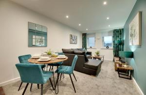 uma sala de estar com uma mesa e um sofá em All Saints Apartments 606 by Week2Week em Newcastle upon Tyne