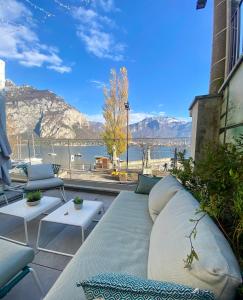 a couch on a patio with a view of the water at LUXURY SUITES ROCOPOM - Lake Front in Lecco