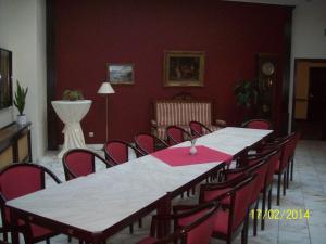 a dining room with a long table and chairs at Hotel Marthahaus in Halle an der Saale