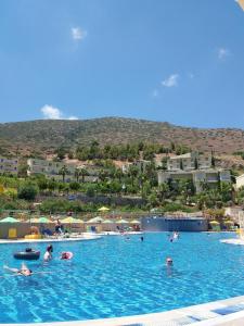 a group of people swimming in a large swimming pool at Aqua Sun Village in Hersonissos