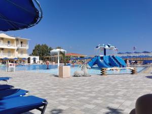 a pool with a water park with a slide at Aqua Sun Village in Hersonissos