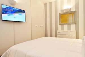 Schlafzimmer mit einem Bett und einem Flachbild-TV an der Wand in der Unterkunft Angy's House in Santa Margherita Ligure
