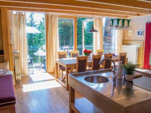 a kitchen with a sink and a table with chairs at Rifugio in Lienz