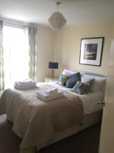 a bedroom with a bed with towels on it at Moonbay apartment in Cardiff