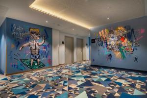a room with graffiti on the walls and a mural of a man at the niu Ridge in Halle an der Saale