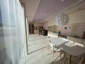 a kitchen with a table and chairs and a chandelier at near shibuya quiet residential area in Tokyo