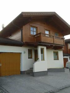 a house with a balcony on top of it at Haus Aria 