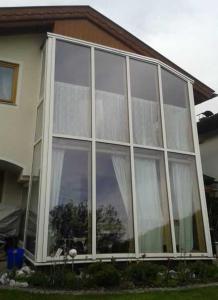 a large glass window on the side of a house at Haus Aria 